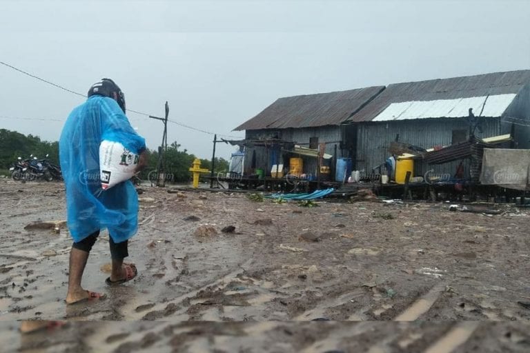 A villager carries a bag of rice on October 12 in Ong Krao village, where residents will have to soon relocate to make way for a development project linked to tycoon Ly Yong Phat. Khuon Narim