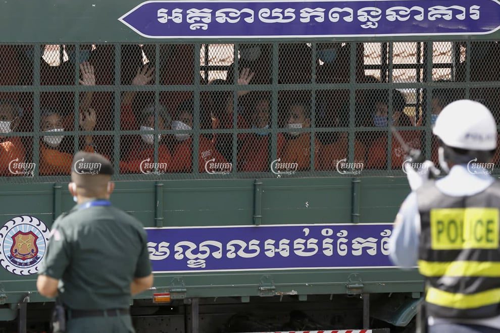 Former CNRP officials leave Phnom Penh municipality court in a prison van after their trial on Tuesday. Panha Chhorpoan