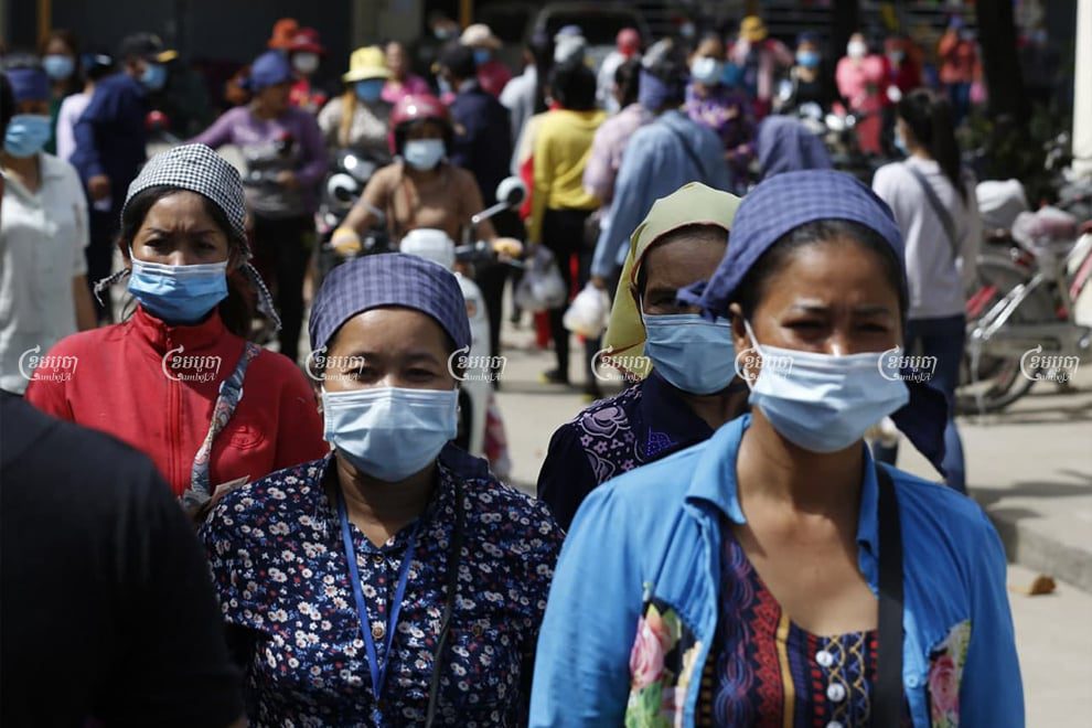 Garment workers leave the factory premises in Phnom Penh for a lunch break on December 2, 2020. Panha Chhorpoan