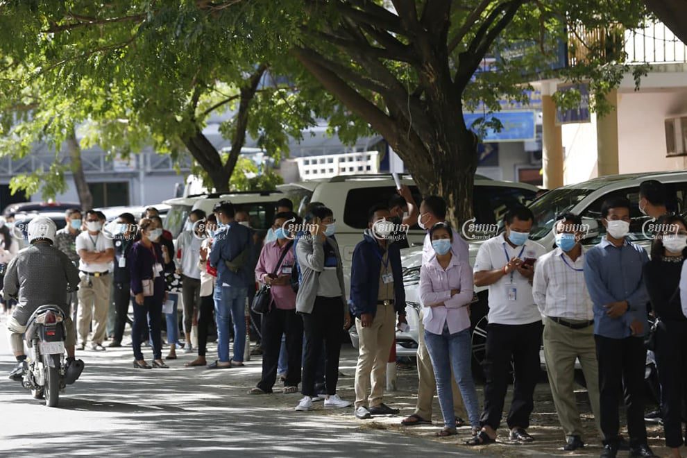 Interior Ministry employees line up to get tested on Monday morning, after another ministry official tested positive for COVID-19. Panha Chhorpoan