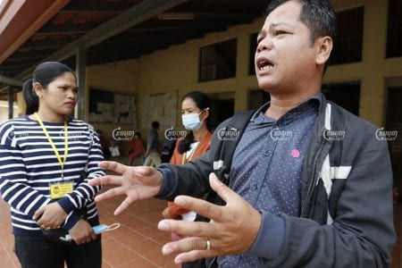 Phin Sophea, a representative for workers at the shuttered Dignity Knitter and ECO Base factories, explains how the sale of machinery seized from the factories fell though, in Kandal province on Tuesday. Panha Chhorpoan