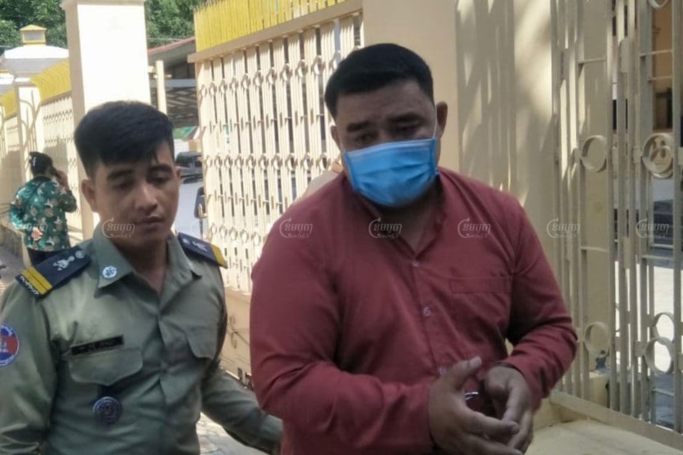 Radio station owner Sok Oudom is escorted by police as he leaves the Kampong Chhnang Provincial Court where he was tried on November 3. Khuon Narim
