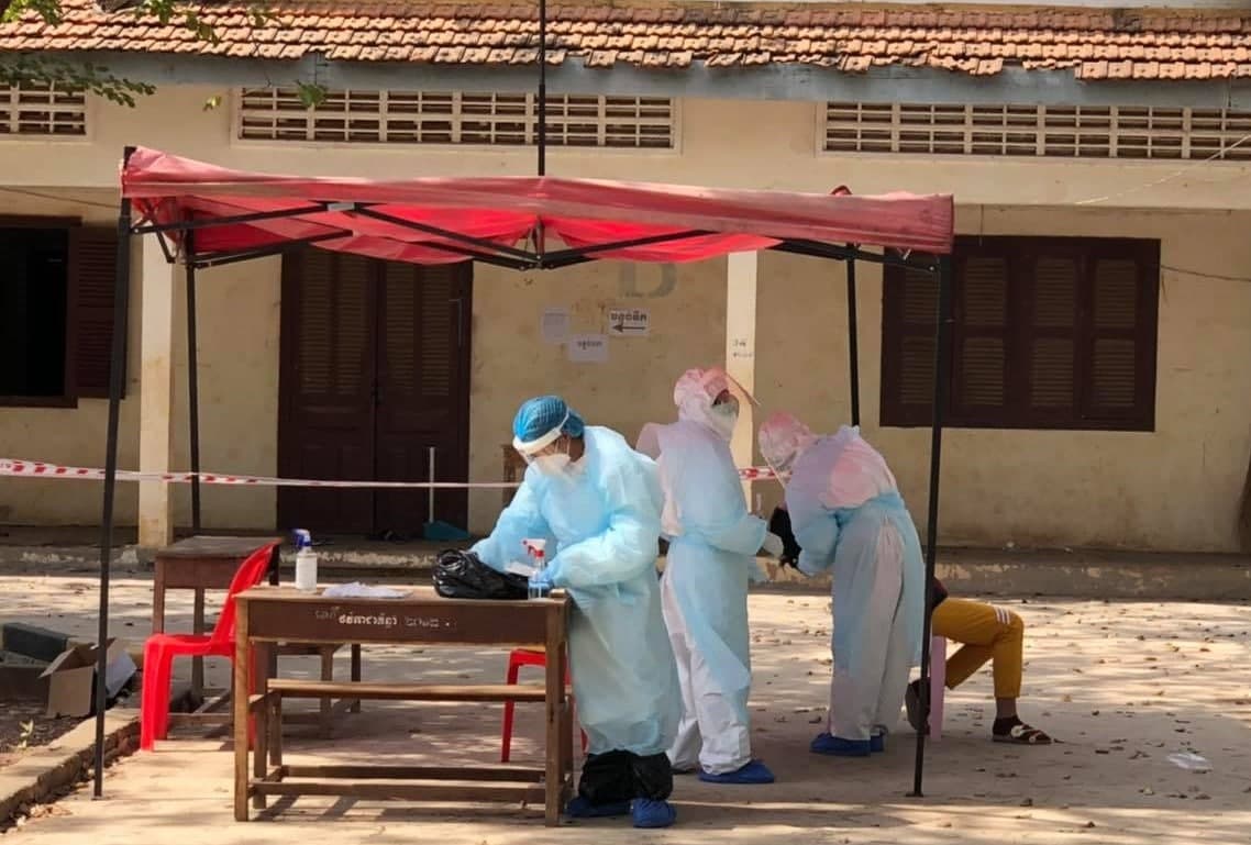Officials take a sample from a migrant worker who returned from Thailand in a photo posted to Battambang Provincial Health Department's Facebook.