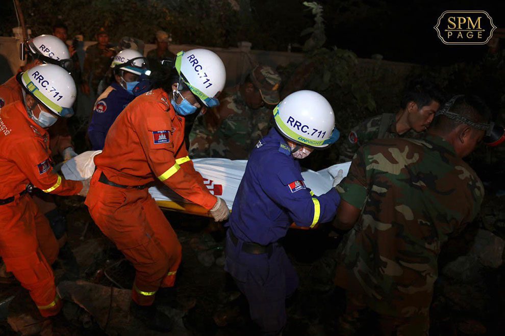 Rescue teams work to remove people trapped under the collapsed Kep building in January 2020.