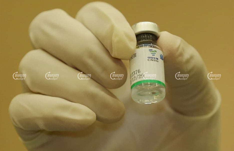 A medical worker shows the Sinopharm vaccine during the 1st day of vaccinations at Phnom Penh’s Calmette Hospital. CamboJA/ Pring Samrang