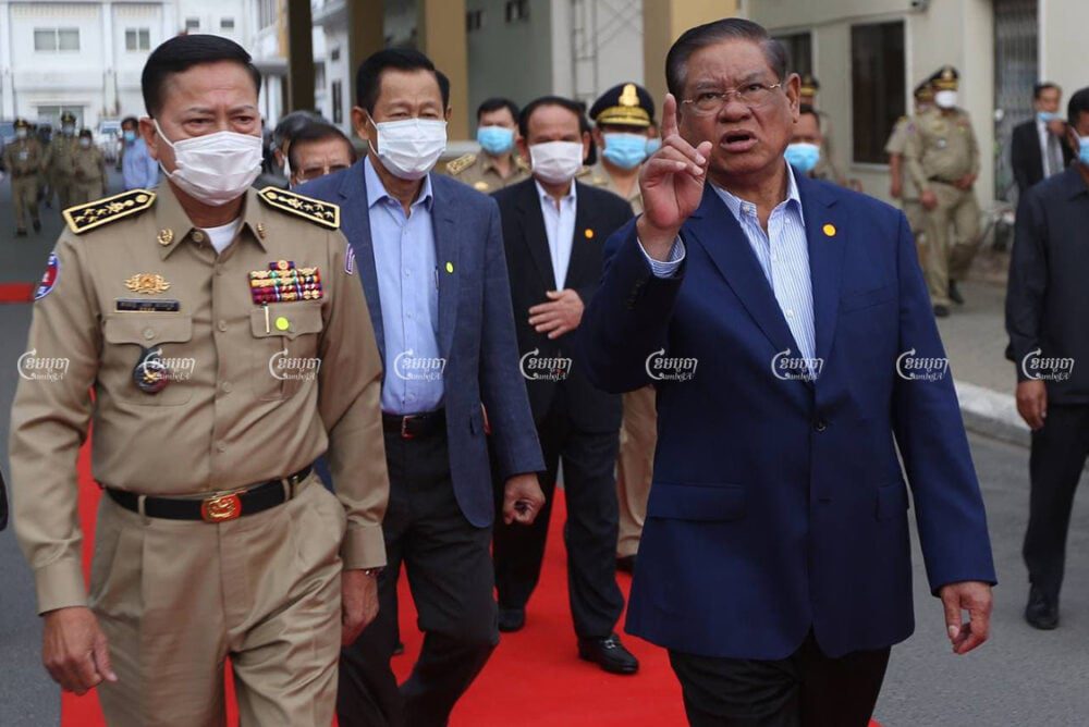 Interior Minister Sar Kheng speaks with National Police Commissioner Neth Savoeun at a ceremony to hand over vehicles to provincial police commissariats, at the Interior Ministry on Tuesday. CamboJA/Pring Samrang