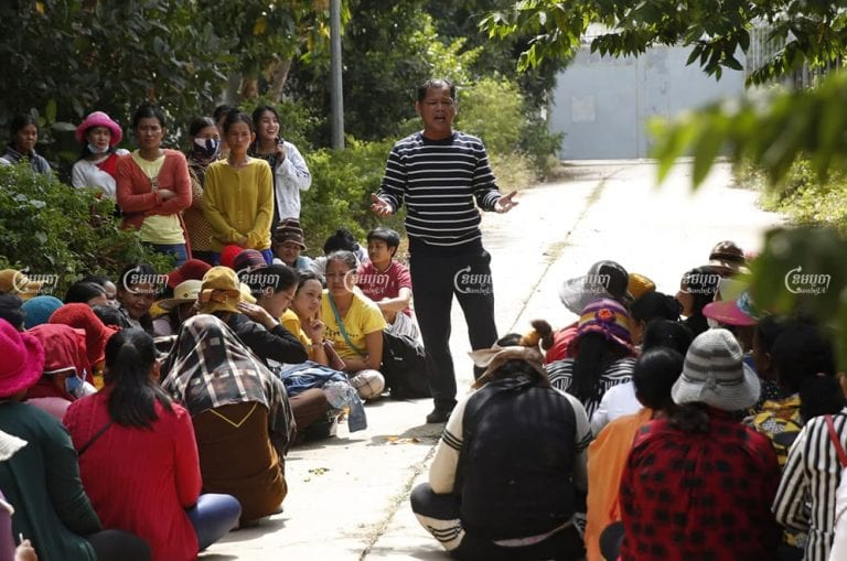 Phin Sophea, a representative for workers at the shuttered Dignity Knitter and ECO Base factories, speaks to colleagues after meeting with authorities to discuss plans to pay outstanding salaries and bonuses following the auction of equipment seized from the factories. Panha Chhorpoan