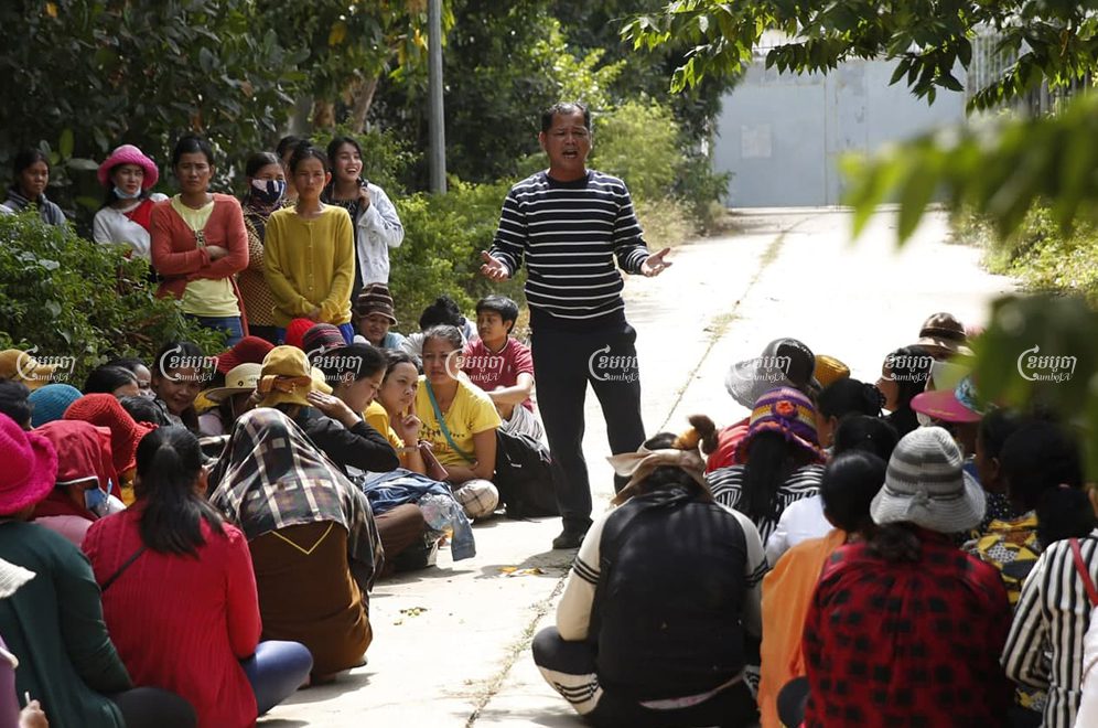 Phin Sophea, a representative for workers at the shuttered Dignity Knitter and ECO Base factories, speaks to colleagues after meeting with authorities to discuss plans to pay outstanding salaries and bonuses following the auction of equipment seized from the factories. Panha Chhorpoan