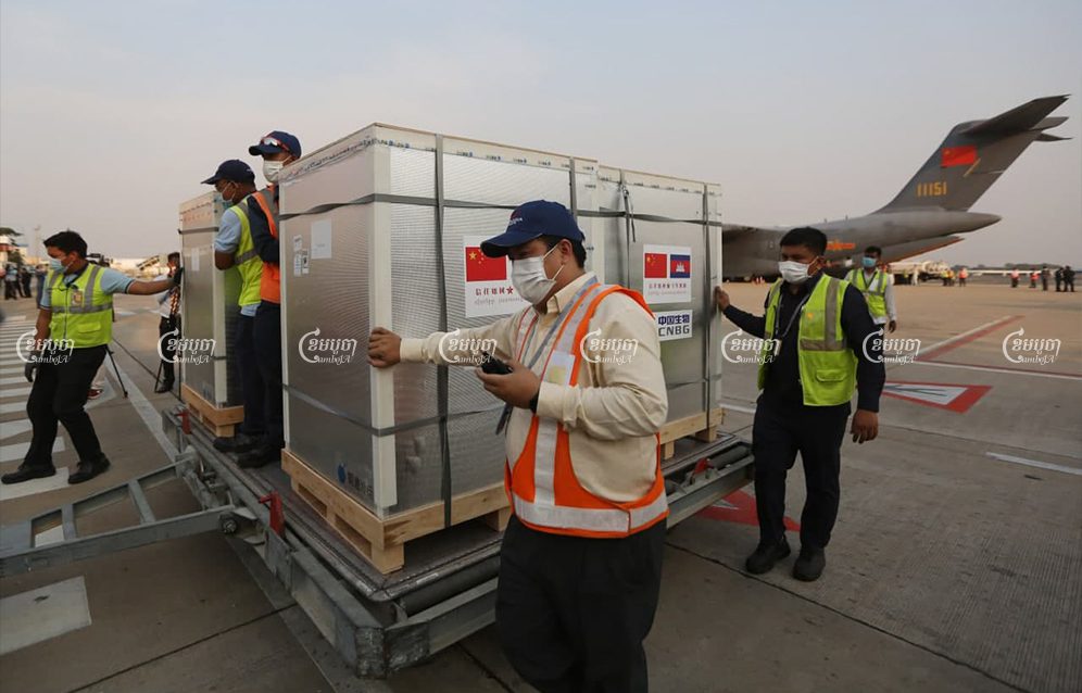 The first COVID-19 vaccines donated by China to Cambodia arrive at Phnom Penh International airport on Sunday. Pring Samrang