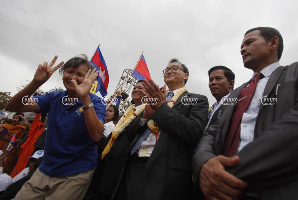 Cambodia National Rescue Party lawmakers (from L) Mu Sochua, Kem Sokha, Sam Rainsy and Long Ry greet supporters at Freedom Park in Phnom Penh after Rainsy returned to Cambodia, on July 19, 2013.CamboJA/ Pring Samrang