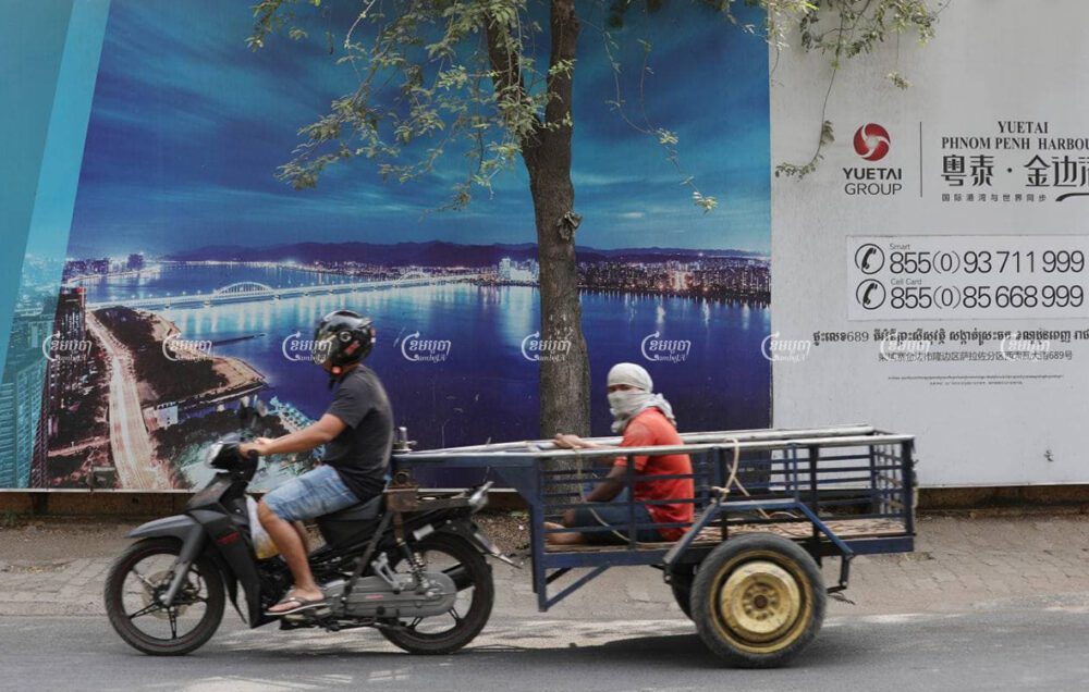 Motorists pass by an advertisement for the Yuetai Group's City Gate development, in Phnom Penh, on February 24. CamboJA/Pring Samrang