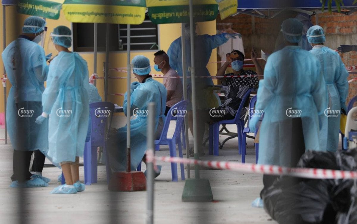 People line up for a health check at the quarantine center in Phnom Penh on March 3, 2021. CamboJA/ Pring Samrang