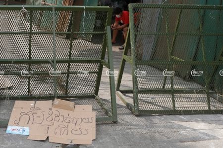 A banner left by a protester reading "My village runs out of food" is seen near barriers at a red zone in Phnom Penh, April 30, 2021. CamboJA/ Panha Chhorpoan
