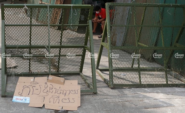 A banner left by a protester reading "My village runs out of food" is seen near barriers at a red zone in Phnom Penh, April 30, 2021. CamboJA/ Panha Chhorpoan