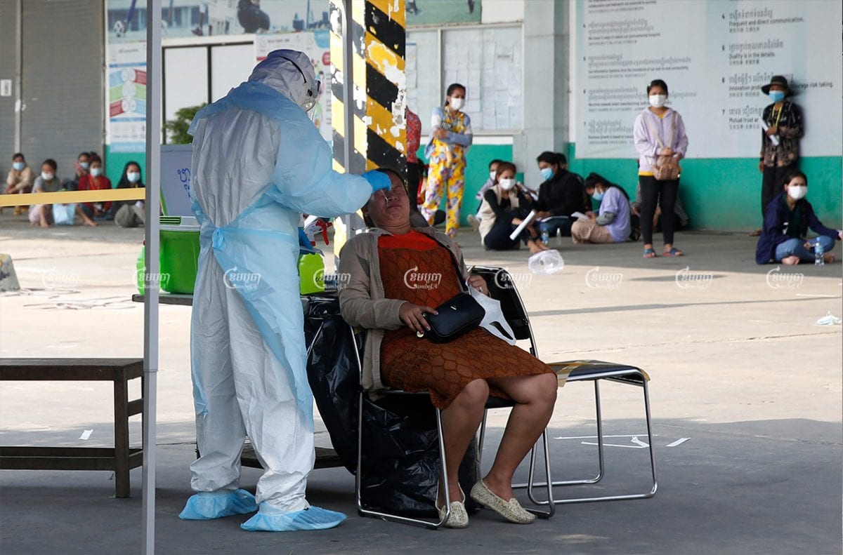 A health worker swabs a garment worker’s nasal cavity for a COVID-19 test at the Din Han factory in Phnom Penh, April 8, 2021. CamboJA/ Panhan Chhorpoan
