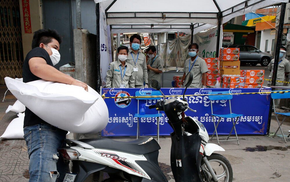 A resident who lives in a red zone in Stung Meanchey commune buys rice from a Ministry of Commerce stall in Phnom Penh, April 23, 2021. CamboJA/ Panha Chhorpoan