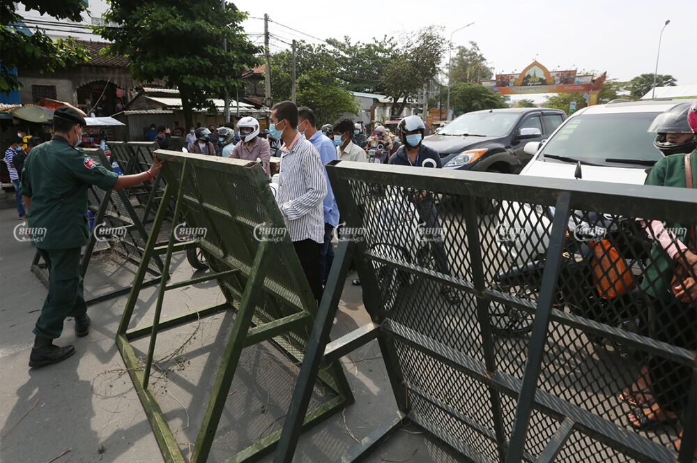 Authorities lock down the main road from Takhmao in Kandal province to nearby Phnom Penh after Prime Minister Hun Sen announced on Wednesday night a two-week lockdown of the metro area, April 15, 2021. CamboJA/ Pring Samrang