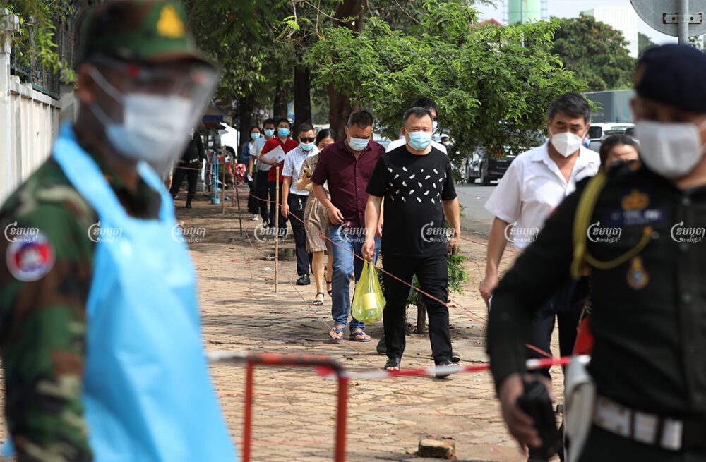 Chinese nationals line up to receive the first dose of vaccine at Preah Ket Mealea Hospital in Phnom Penh, April 10, 2021. CamboJA/ Pring Samrang