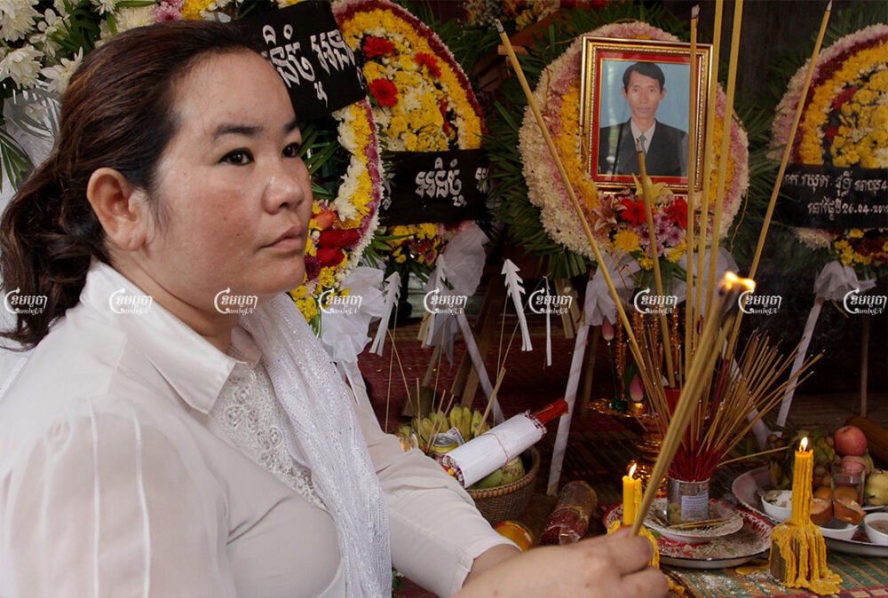 Chut Wutty's wife burns incense during a funeral ceremony for the murdered environmental activist at his home in Kandal province, April 28, 2012. CamboJA/ Panha Chhorpoan