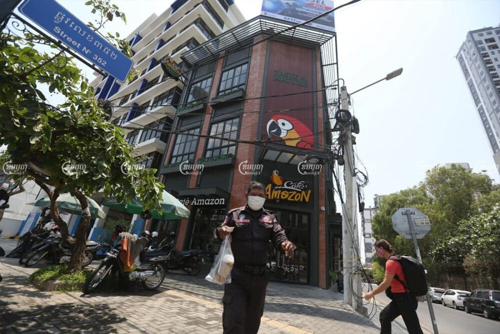 Customers in front of a coffee shop in Phnom Penh ahead of the curfew on April 1, 2021. CamboJA/ Pring Samrang
