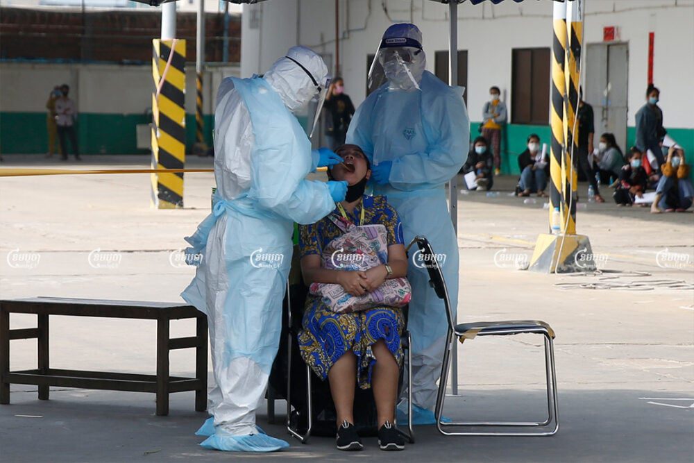 Health Officials give a COVID-19 test to a worker at the Din Han factory after more workers tested positive, April 8, 2021. Panha Chhorpoan