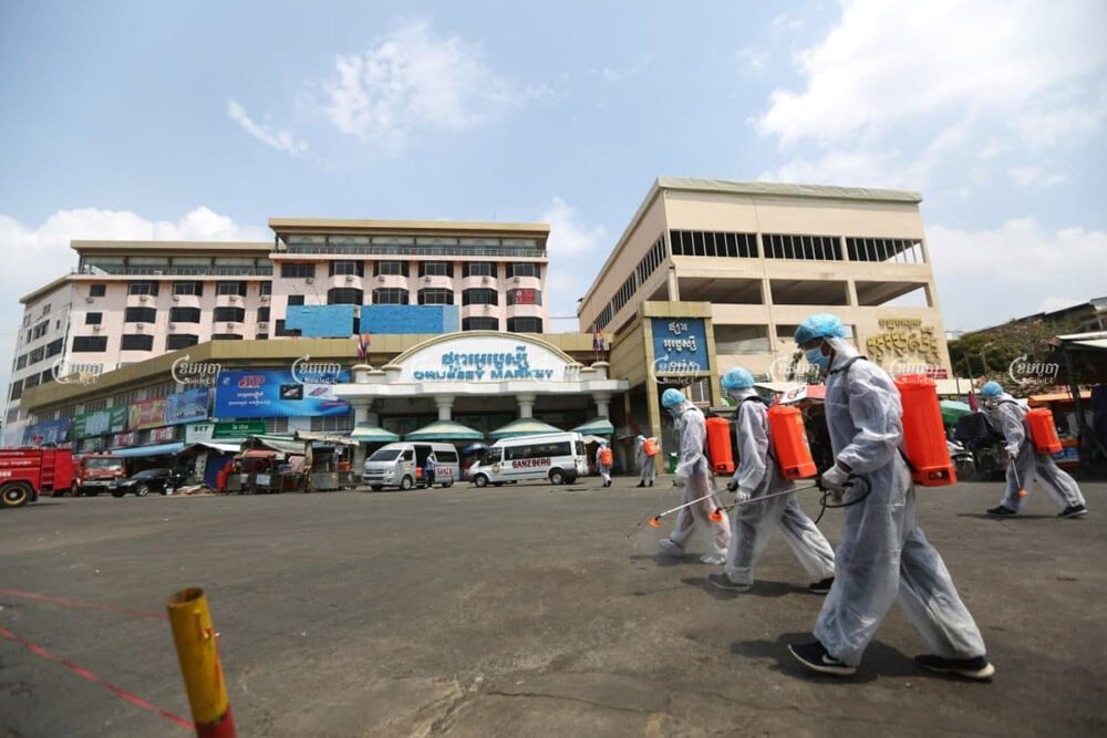Healthcare workers disinfect the roads in front of O’Russei market, which was closed after vendors and security guards tested positive for COVID-19, in Phnom Penh, April 5, 2021. CamboJA/ Pring Samrang