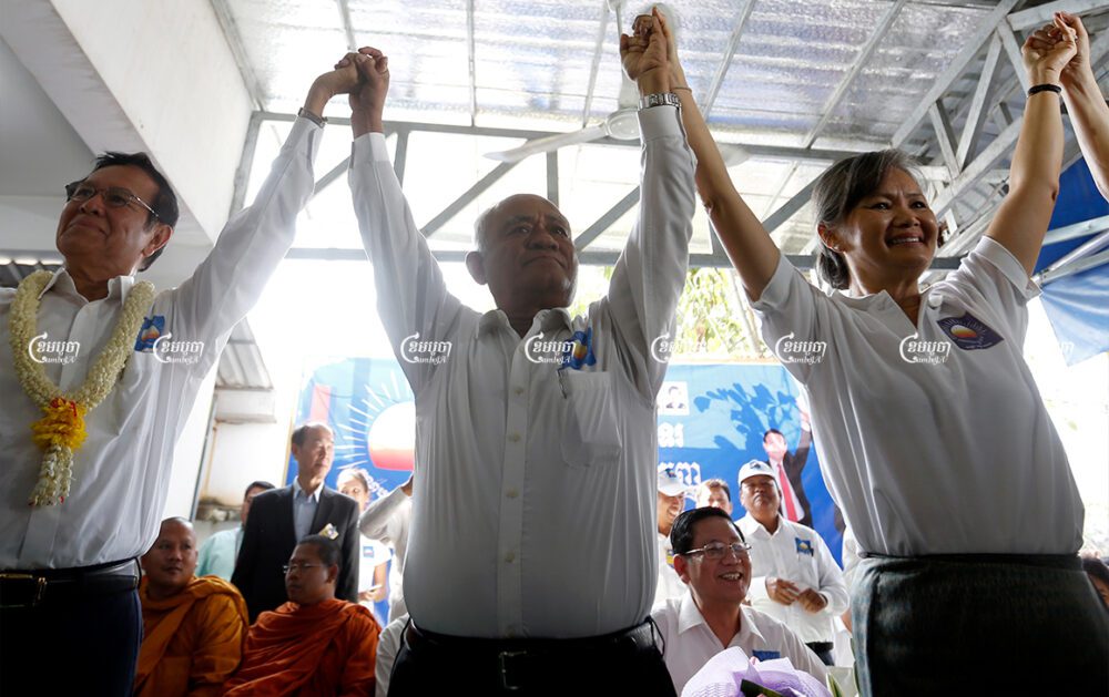 (From L) Then-CNRP president Kem Sokha, co- vice president Pol Ham, and vice president Mu Sochua cheer during the CNRP congress for a new president in Phnom Penh. Picture taken on March 2, 2017. CamboJA/ Pring Samrang