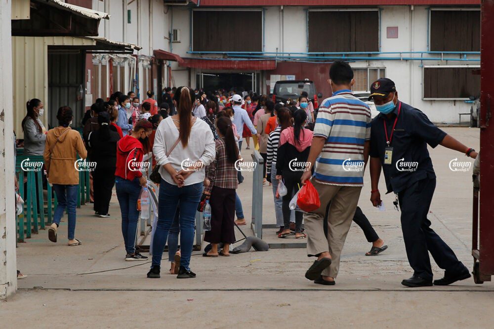 Garment workers enter a factory for their morning's work in the Dangkor district of Phnom Penh, May 27, 2021. CamboJA/ Panha Chhorpoan