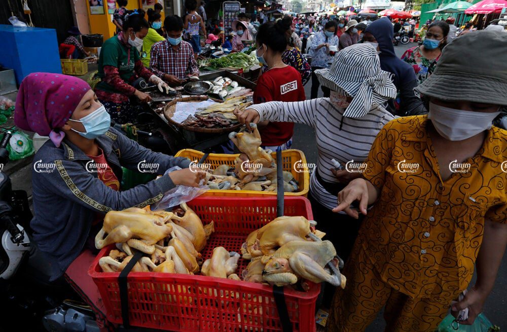 Vendors sell chicken and other food supplies on a street after more than a month of market closures to prevent the spread of COVID-19, May 20, 2021. CamboJA/ Panha Chhorpoan