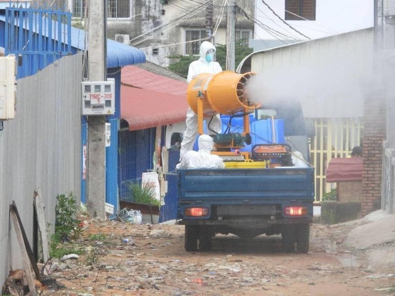 Health officials spray sanitizer to fight COVID-19 in a red zone area of Sihanoukville on May 6, in a photo posted on the Preah Sihanouk provincial administration's Facebook page.