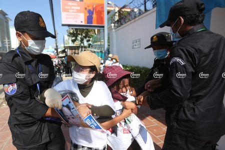 Authorities seized banners from the family members of activists from the forcibly dissolved CNRP as they submittes a petition to a UN office in Phnom Penh, June 4, 2021. CamboJA/ Pring Samrang