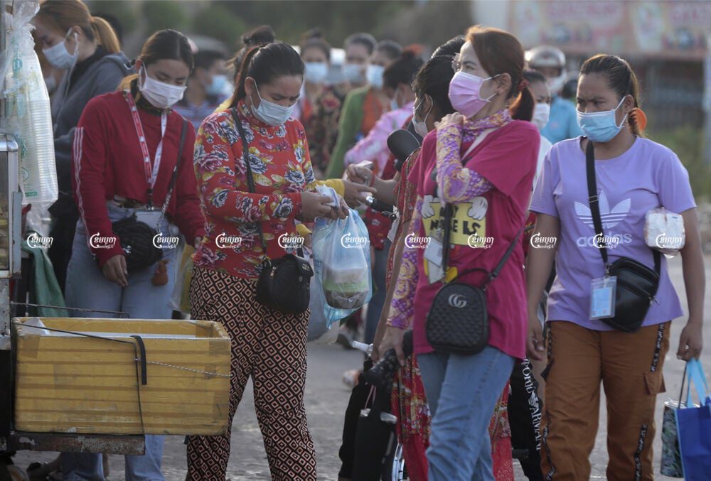 Garment workers arrive at their factory at Kakap II commune, Pur Senchey district in Phnom Penh, June 14, 2021. CamboJA/ Panha Chhorpoan
