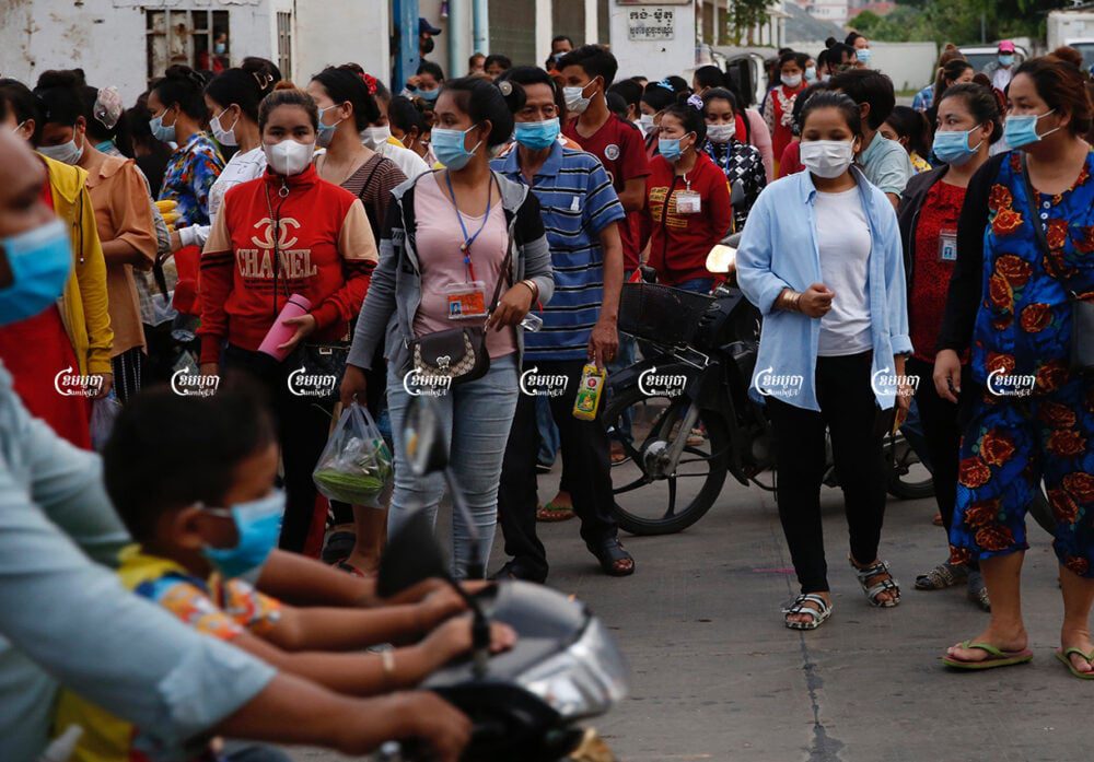 Garment workers leave a factory after finishing their work, in Phnom Penh, June 2, 2021. CamboJA/ Panha Chhorpoan