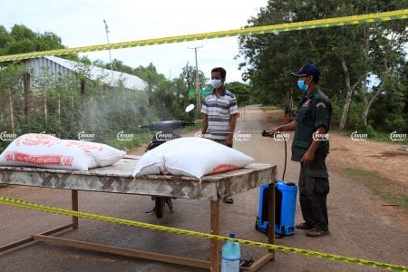 Local authorities spray down a moto entering Kampong Khlaing commune in Soutr Nikum district following a COVID-19 outbreak, June 10, 2021. CamboJA/ Panha Chhorpoan