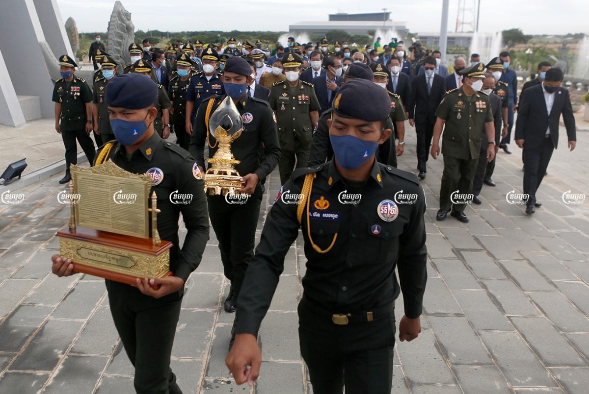 Soldiers carry Cambodia's first drop of crude oil during a ceremony at Phnom Penh's Win Win Monument, June 9, 2021. CamboJA/ Panha Chhorpoan