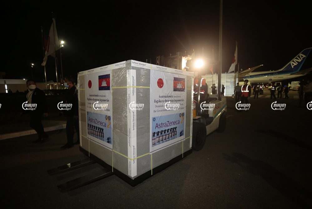A box with 332,000 doses of AstraZeneca donated by Japan arrives at Phnom Penh International airport on Friday night, July 23, 2021. CamboJA/ Panha Chhorpoan