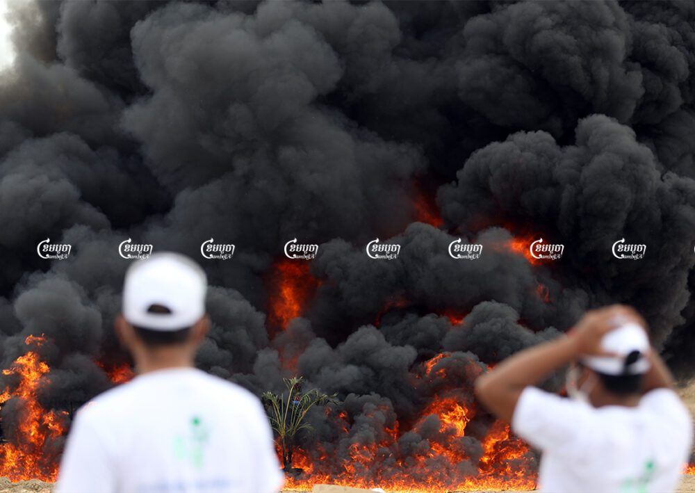 Officials look on as seized drugs are burned at a ceremony marking the International Day against Drug Abuse and Illicit Trafficking in Phnom Penh, July 19, 2021. CamboJA/ Pring Samrang