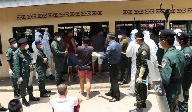 Police and military police are deployed at the Chivith Thmey Phnom Bak Center in Banteay Meanchey province to crack down on protesting patients demanding to be treated at home after having tested positive for COVID-19. Photos posted on Banteay Meanchey provincial administration's Facebook page on August 18, 2021.