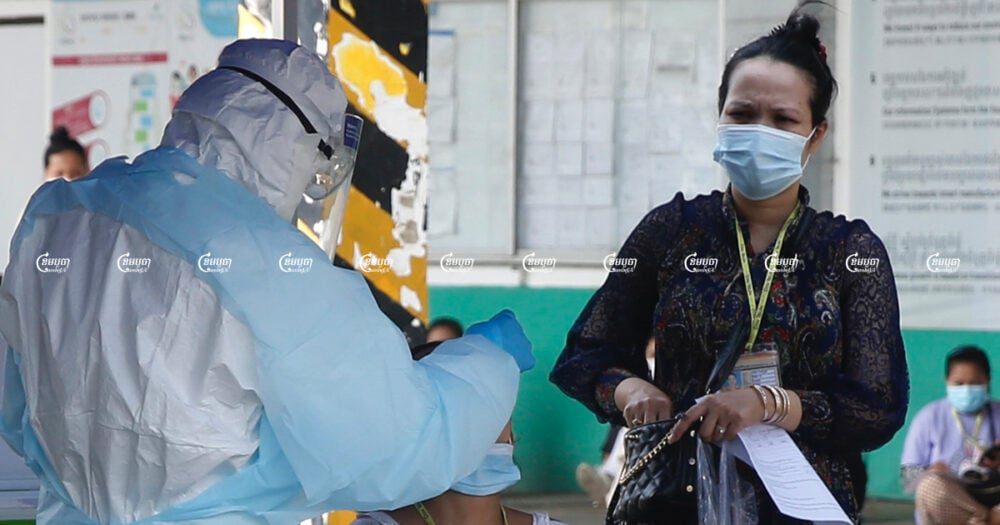 A health worker tests a garment worker for the Covid-19 at a factory in Phnom Penh. Picture taken April 15, 2021. CamboJA/ Panha Chhorpoan