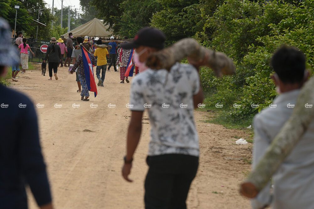 Villagers gather to demonstrate in front of police barricades where authorities blocked a road leading to their farmland, which is being cleared to prepare the site for a planned airport in Kandal Stung district, Picture taken on September 12, 2021. CamboJA/ Panha Chhorpoan