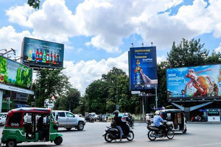 Billboards advertising alcohol seen along main roads as commuters cross the Chamkarmon intersection in Phnom Penh, October 29, 2021. (Kann Vicheika/VOA Khmer)