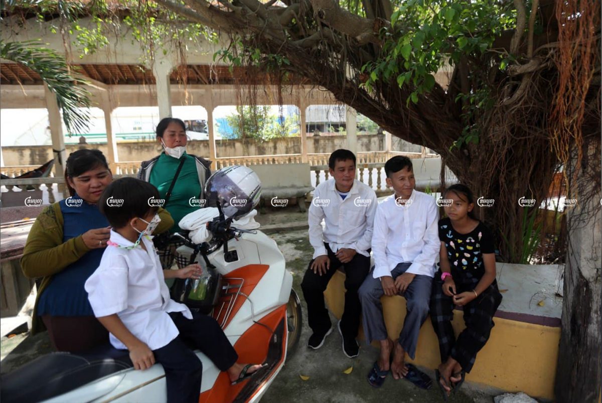 Former CNRP activists Chum Puthy and Chhour Pheng sit at Angkor Metrey pagoda after their release from Prey Sar prison on the outskirts of Phnom Penh, November 5, 2021. CamboJA/ Pring Samrang