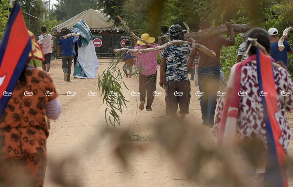 Villagers gather to demonstrate in front of police barricades where authorities blocked a road leading to their farmland, which is being cleared to prepare the site for a planned airport in Kandal Stung district, Picture taken on September 12, 2021. CamboJA/ Panha Chhorpoan