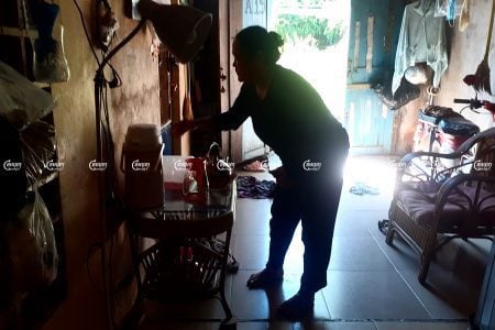 Muong Samnang cleans her home in the Chamkarmon district of Phnom Penh, December 8, 2021. CamboJA/ Chea Sokny