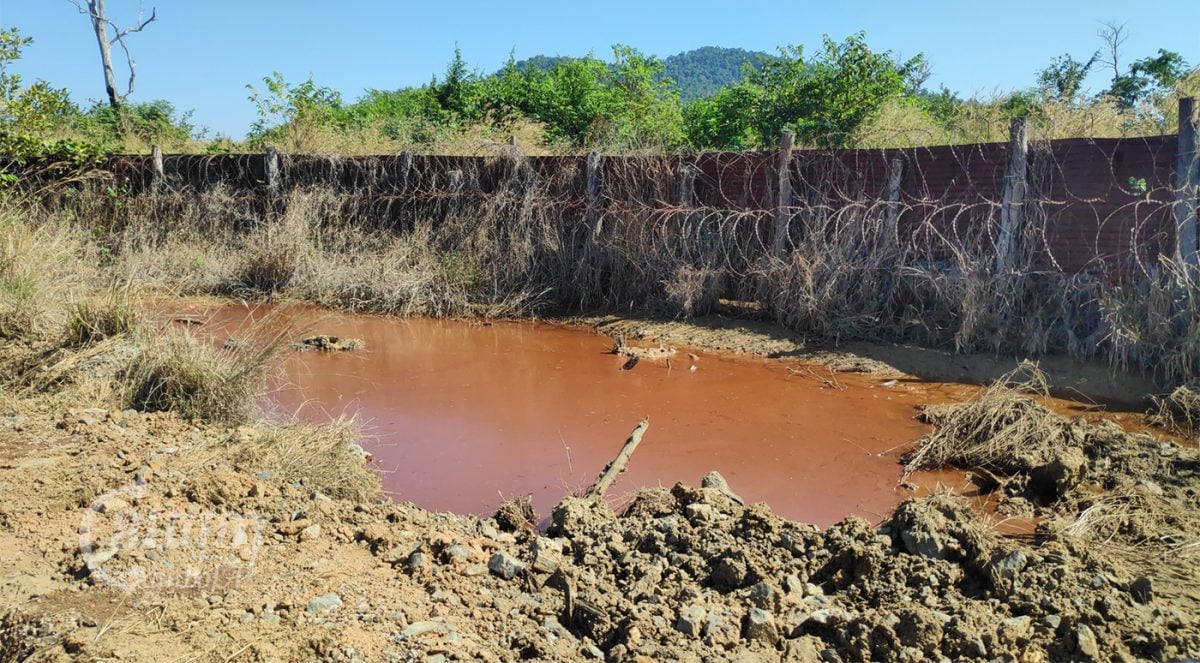 An orange pond, which villagers suspected of having high toxin levels, can be seen near the mining operations of Delcom in Rovieng district, Preah Vihear province. Photo taken on December 14, 2021. CamboJA / Vann Vichar