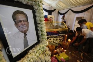 People pray in front of a portrait of Kem Ley after he was shot dead in Phnom Penh, Picture taken July 24, 2016. CamboJA/ Pring Samrang