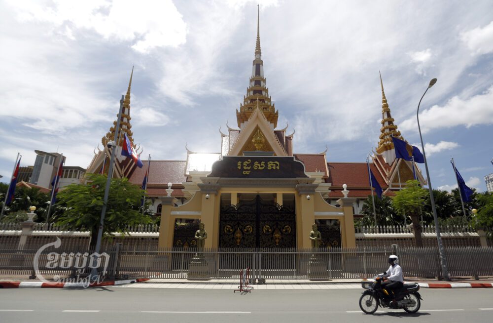 A man drives past the National Assembly in Phnom Penh on July 10, 2017. CamboJA/ Pring Samrang