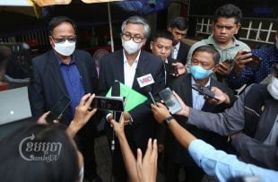 Yeng Virak, center, president of the Grassroots Democratic Party, speaks to the media after submitting a petition to the National Assembly, July 21, 2022. CamboJA/Pring Samrang