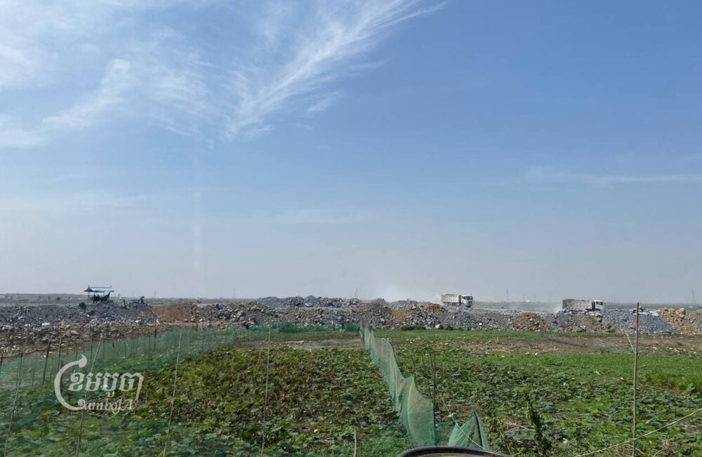Trucks fill in Boeng Tamok lake on February 25, 2023. (CamboJA/Runn Sreydeth)