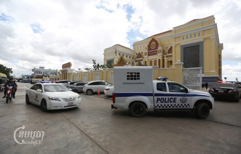Police bring tycoon Hy Kimhong for questioning at the Phnom Penh Municipal Court on August 9, 2023. (CamboJA/Pring Samrang)